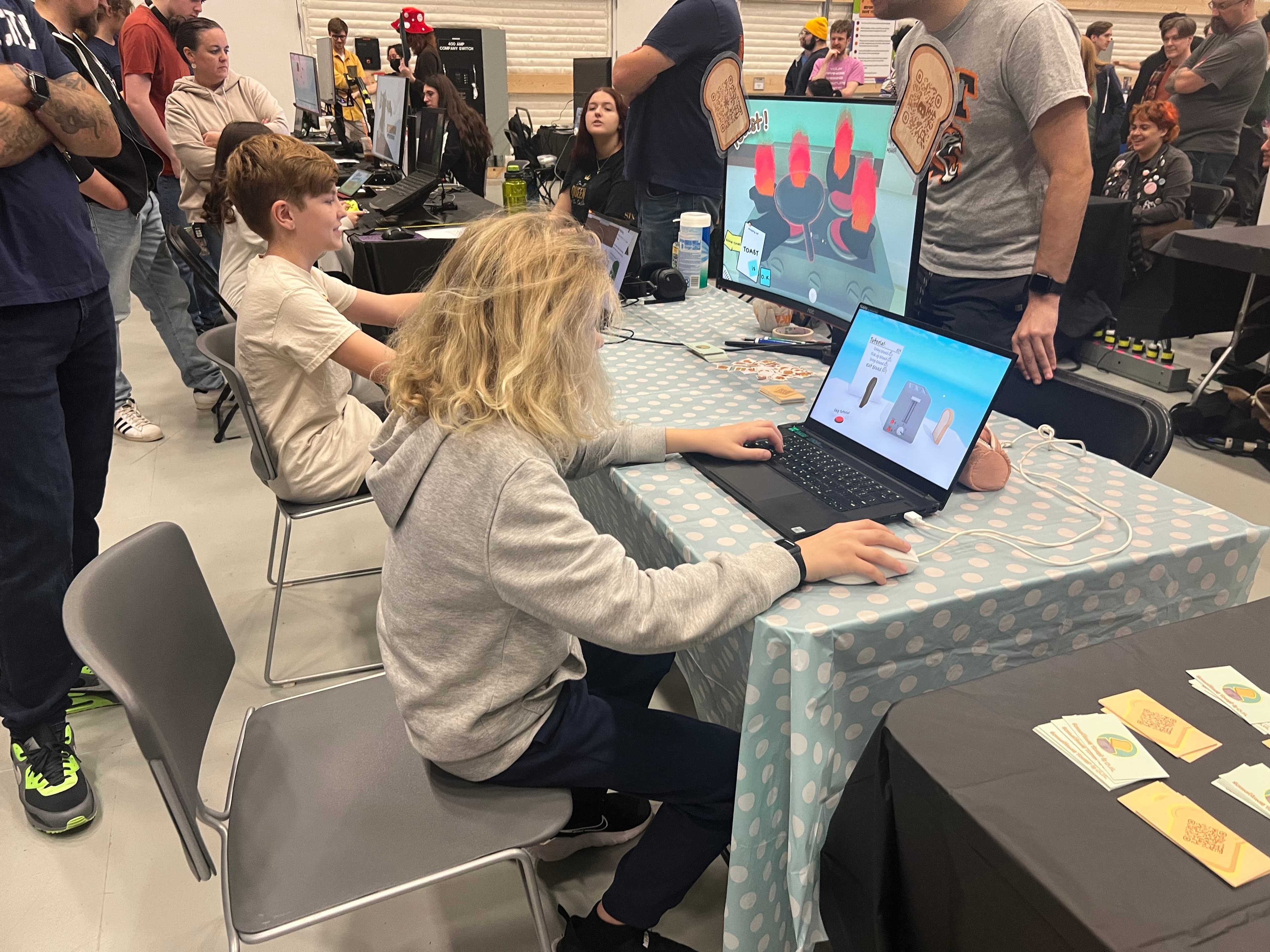 A visitor playtesting Sometimes Toast is O.K. at Rochester Game Festival