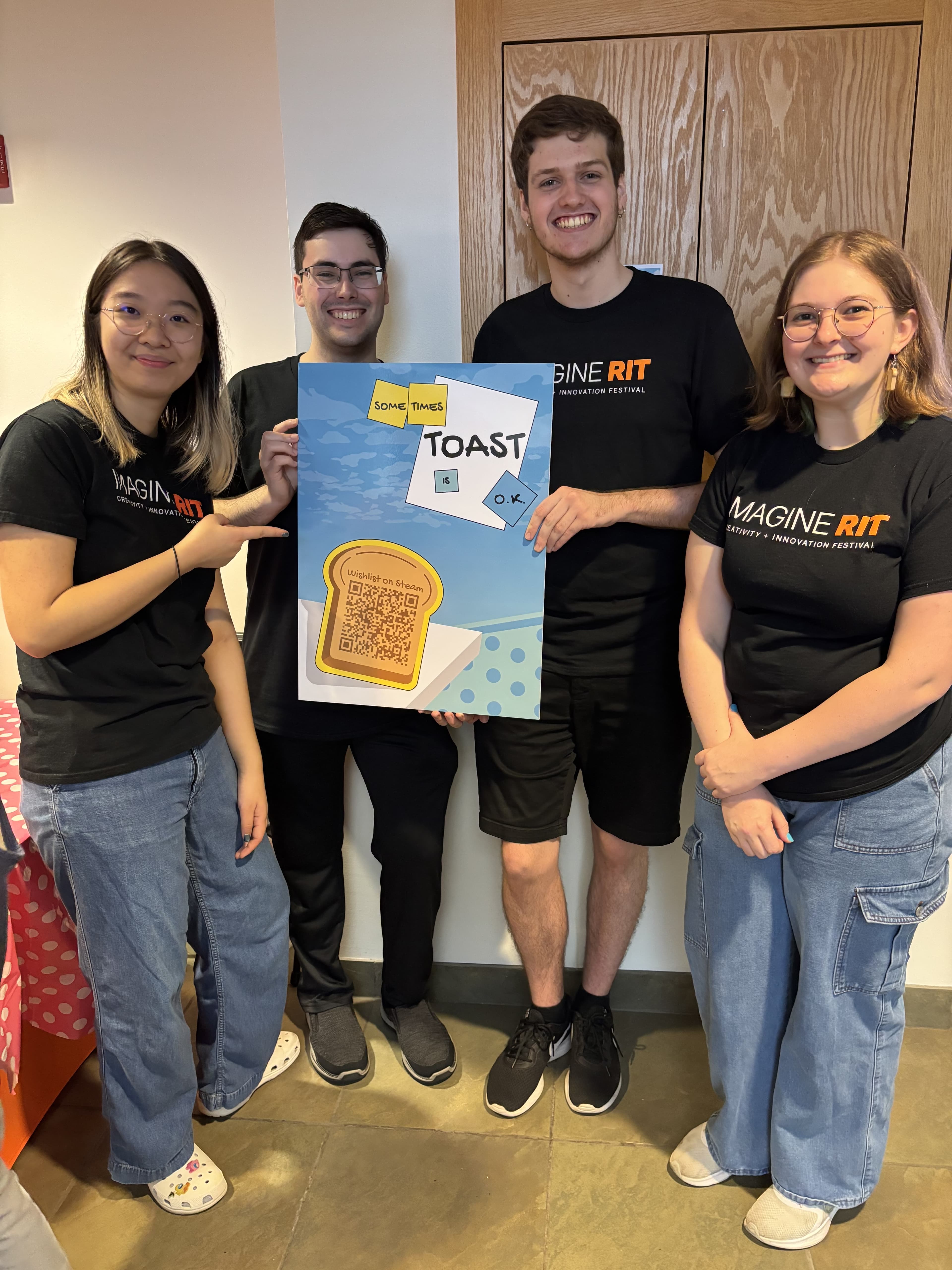 Team Toast posing beside its Imagine RIT display